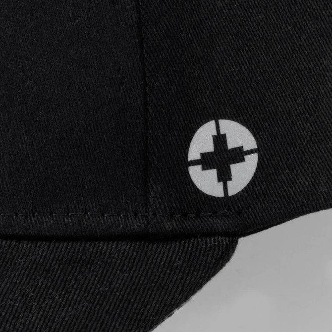 A black cap featuring a circular logo on the side. It has a six-panel design.