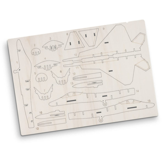 A wooden model kit of a jet fighter, featuring various pre-cut pieces on a light wood board, with a logo present.