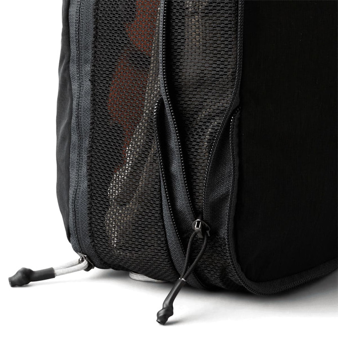 A black packing cube with a mesh side and a zippered opening, showcasing its compact design.