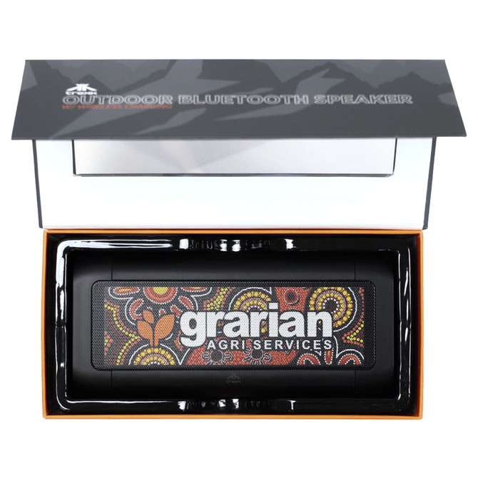 A black outdoor Bluetooth speaker with a colourful Aboriginal art design, presented in a sleek box with branding.