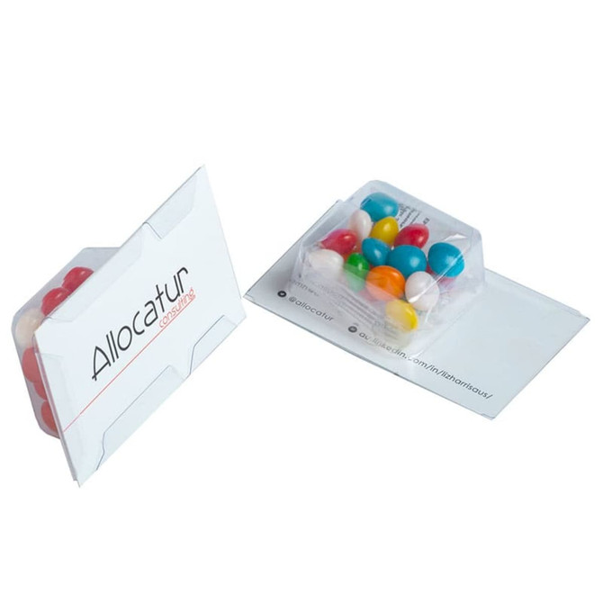 A promotional product featuring colourful chewy fruit sweets in a clear container, packaged in a white card holder with branding.