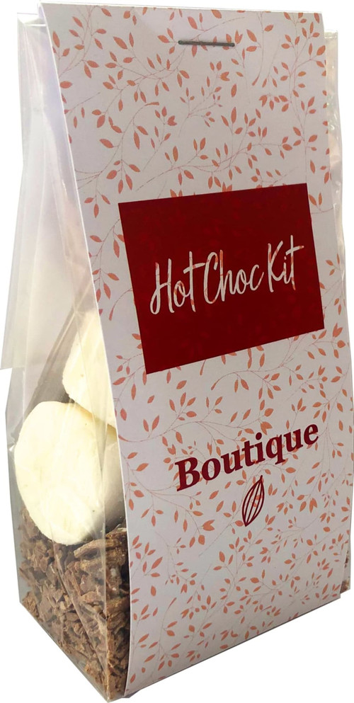 A clear bag containing chocolate flakes and marshmallows, with a decorative label featuring floral motifs in red and white.