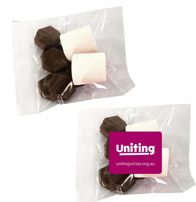 A clear package containing dark chocolate pieces and marshmallows, featuring a logo.