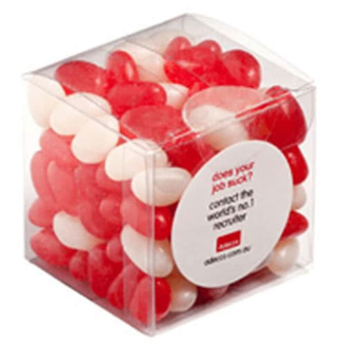A clear cube containing red and white jelly beans, showcasing a mix of colours in a transparent package.