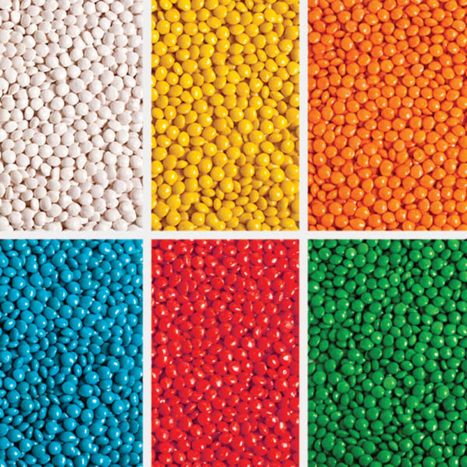 A collection of brightly coloured chewy fruit candies in six sections: white, yellow, orange, red, blue, and green.