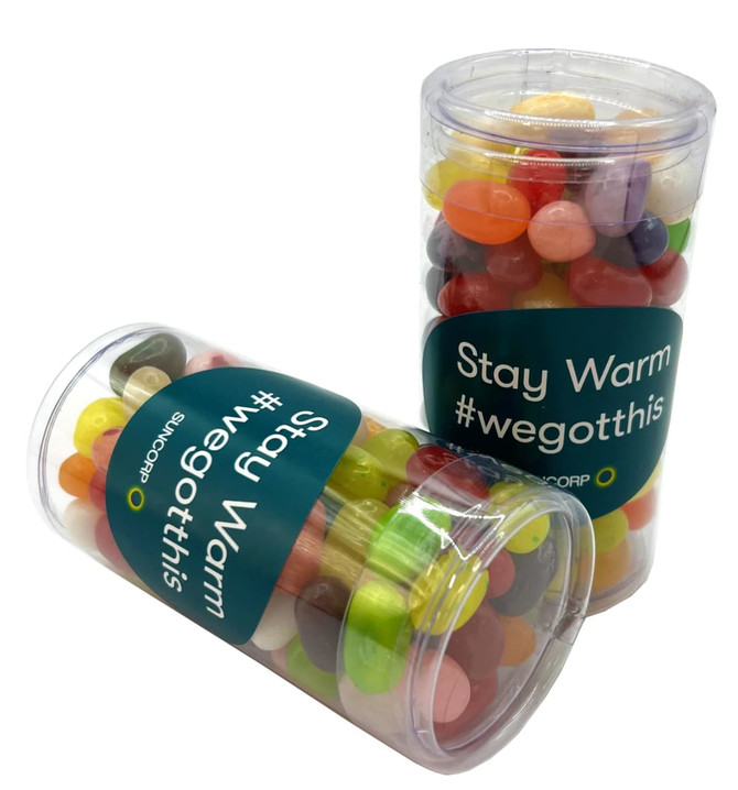 A transparent PET tube containing colourful Jelly Belly jelly beans, with a visible branding label.