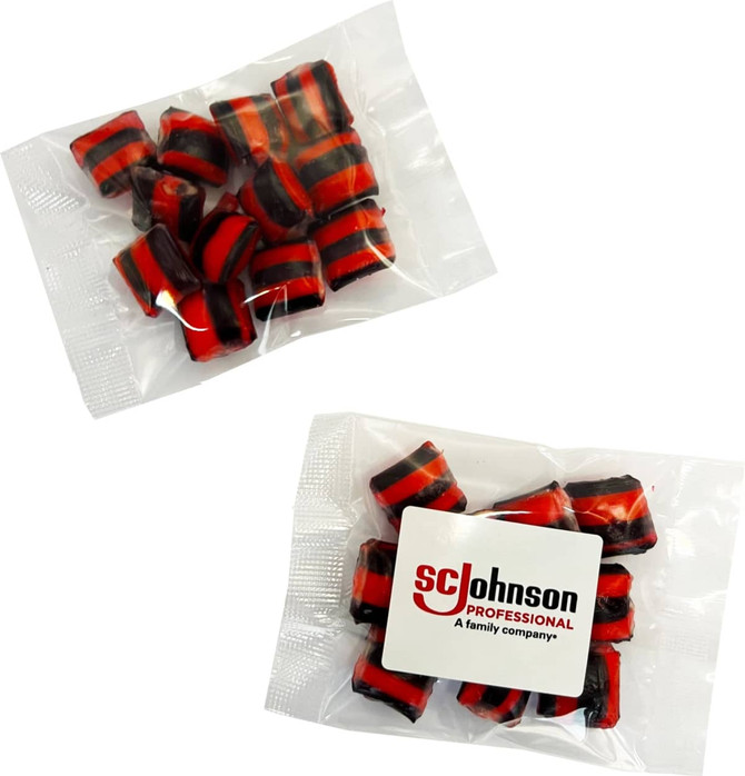 A clear bag containing red and black striped humbugs. The bag has a logo on it.