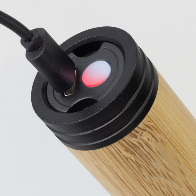 A bamboo torch with a charging port, featuring a red indicator light, set against a plain background.