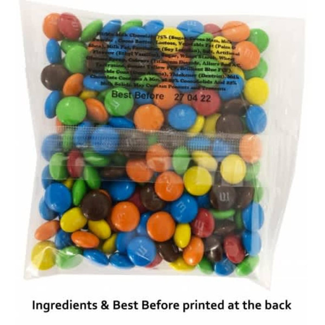 A clear bag filled with Mini M&Ms, featuring bright colours like blue, green, yellow, and orange.