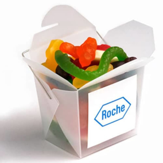 A frosted noodle box filled with mixed lollies in bright colours, including gummy bears and sour worms.