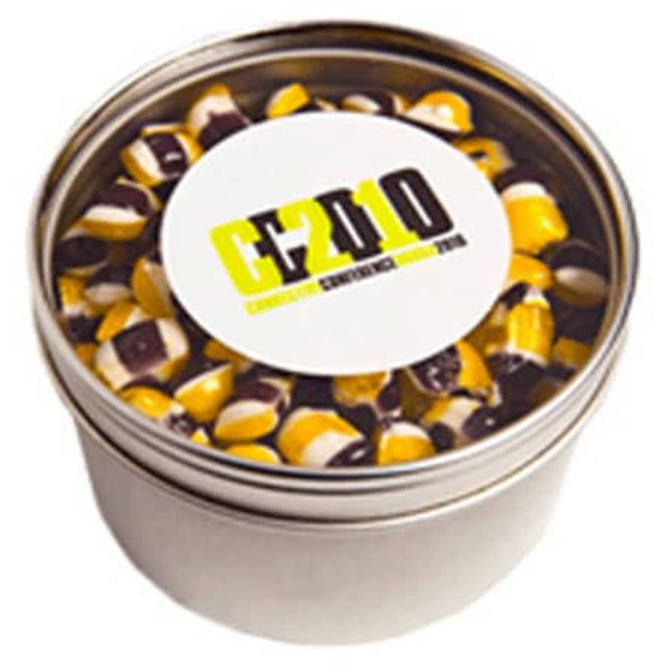 A small round tin with a silver finish, containing humbugs in yellow and black stripes. Features a logo on the lid.