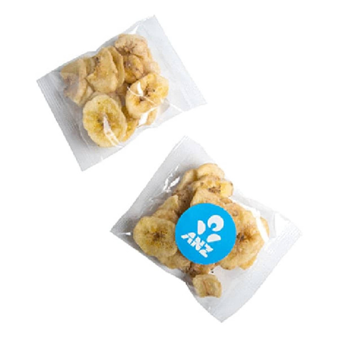Two transparent packets of banana chips, featuring yellow slices of dried bananas and a logo on one packet.