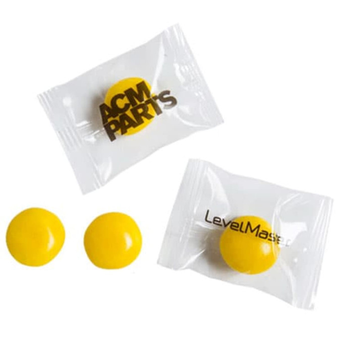 Individually wrapped yellow chewy fruit candies, three pieces total, with branding on the packages.