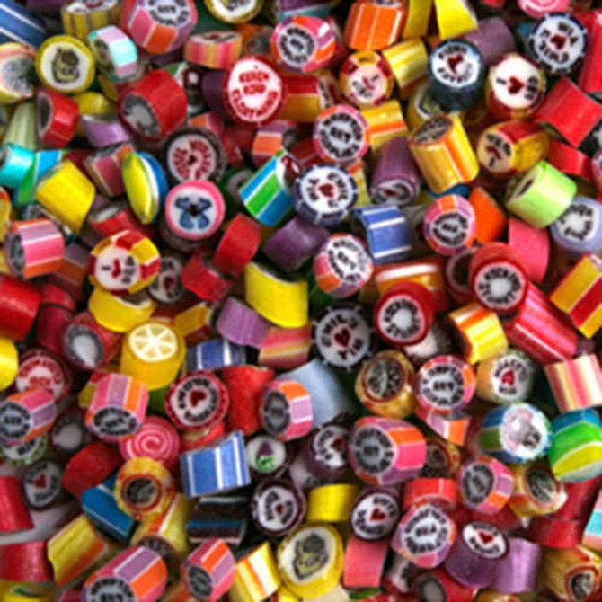 A vibrant assortment of personalised rock candy pieces in various colours and designs, with a mix of patterns.