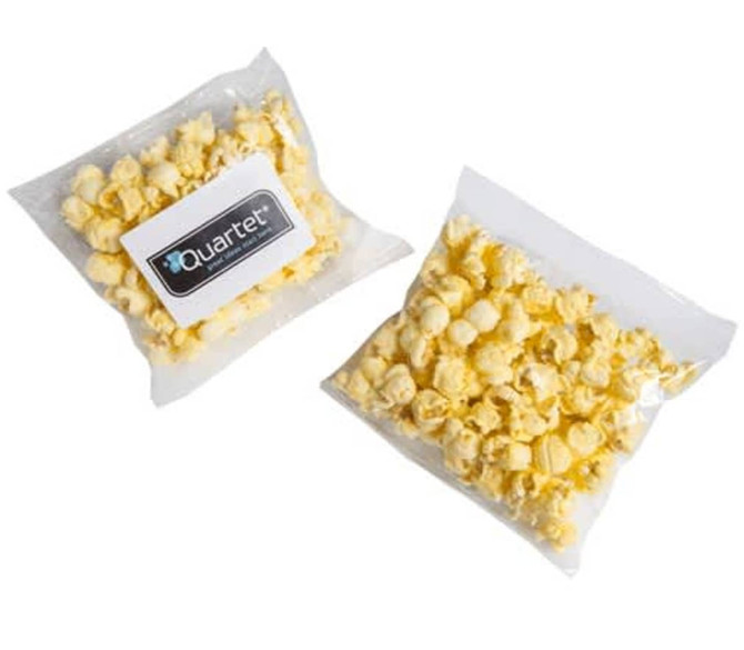 A clear bag of yellow buttered popcorn, featuring a logo on the packaging.