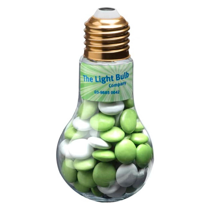 A light bulb-shaped container filled with green and white chocolate beans, featuring a gold-coloured top and a logo.
