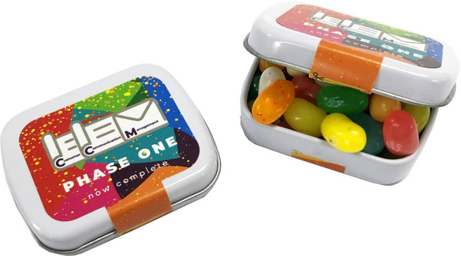 A small rectangular tin filled with colourful JELLY BELLY jelly beans. The tin features a logo design.