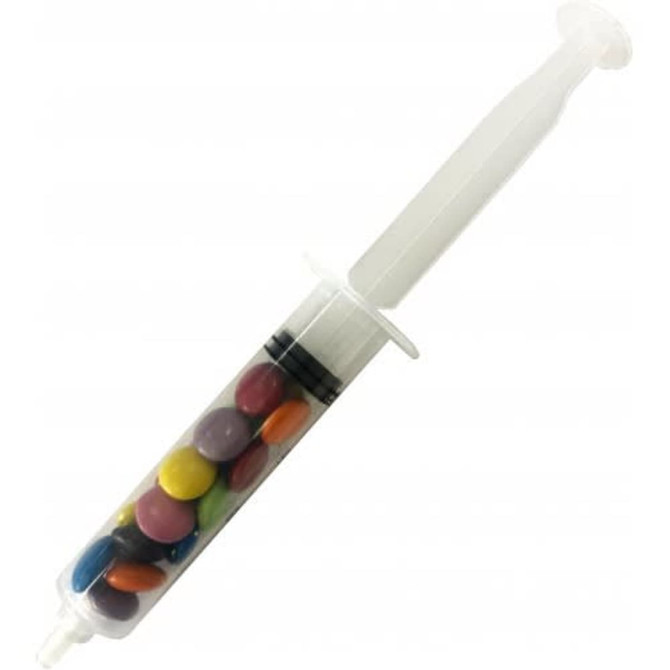 A syringe filled with colourful choc beans, featuring a clear body and a white plunger.
