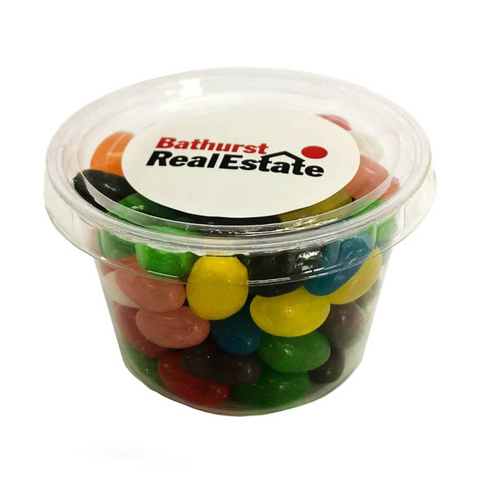 A clear tub filled with assorted colourful jelly beans, including red, yellow, green, and purple varieties. It has a logo on top.