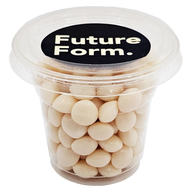 A clear tub filled with white chewy mints, featuring a black lid with a logo.