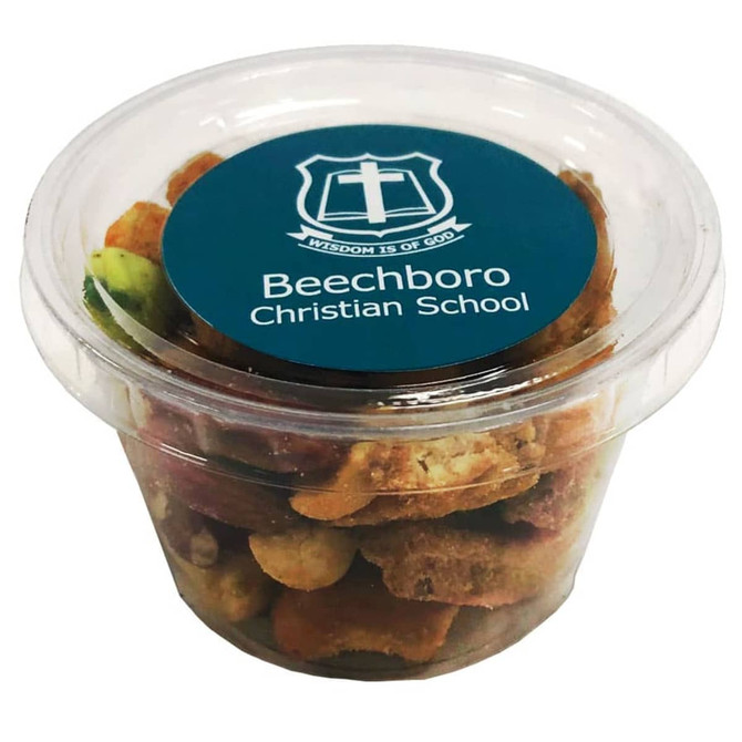 A clear tub filled with mixed nuts and savoury snacks, featuring a blue lid with a logo.
