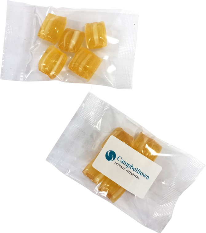Eucalyptus lollies in a clear packet, featuring yellow lozenges and a logo on one side.