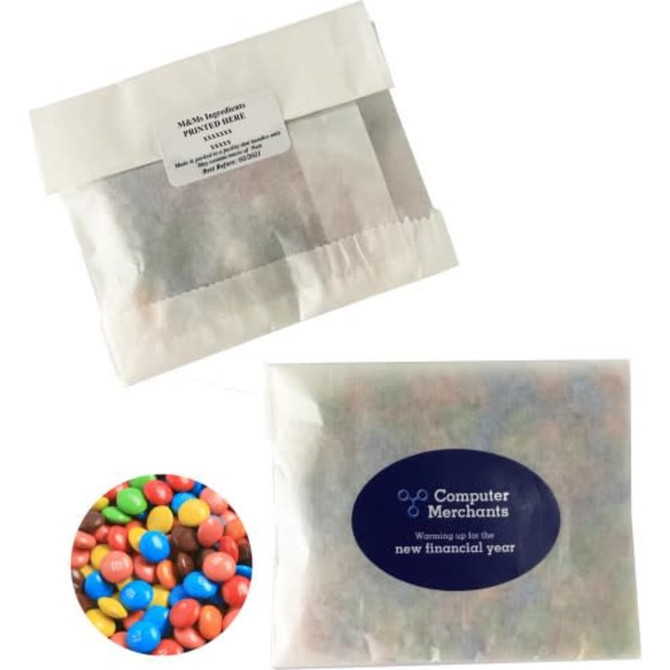 A kraft paper bag containing mixed M&Ms in various colours, featuring a logo on the packaging.