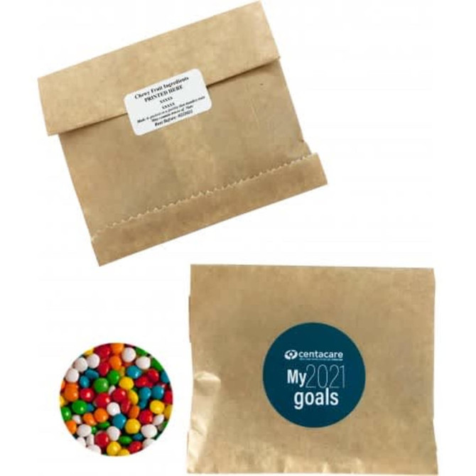 A kraft paper bag containing chewy fruit candies in vibrant colours, alongside a branded circular logo.
