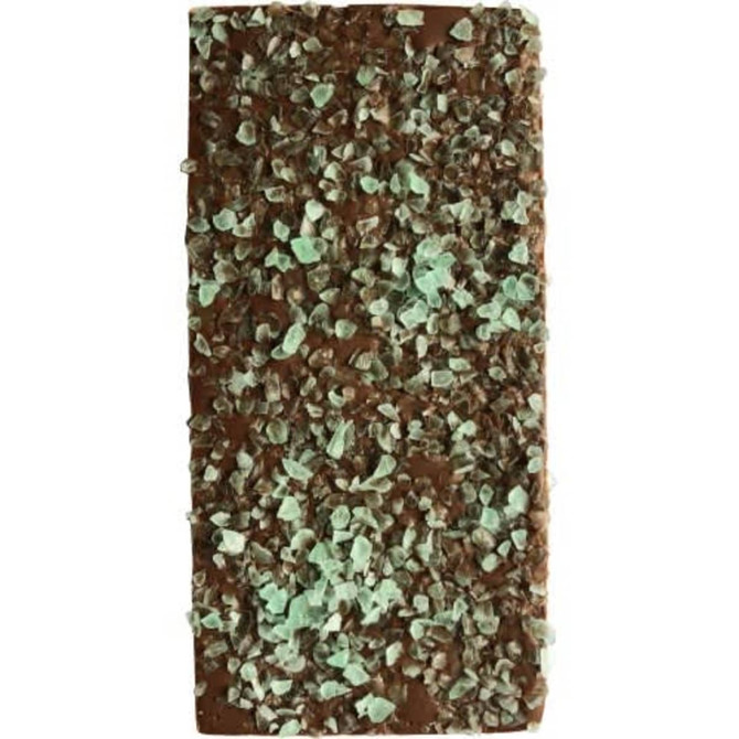 A chocolate bar topped with green peppermint crystals, showcasing a rich brown chocolate base and a sprinkle of minty pieces.