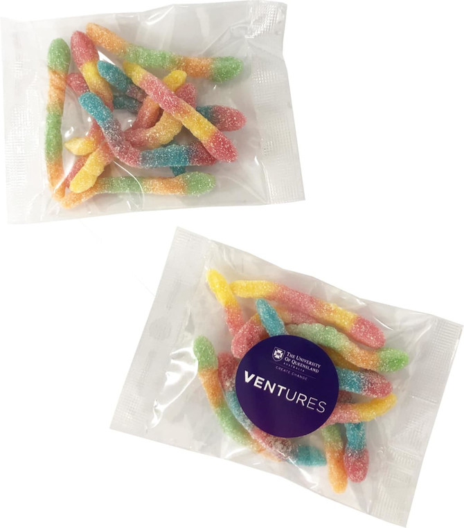 A packet of colourful gummy sour worms in pink, yellow, blue, and green, with a logo on the packaging.