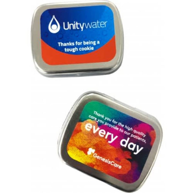 A small rectangular tin with colourful branding, featuring sugar-free lollies inside. It's silver with vibrant designs on both sides.