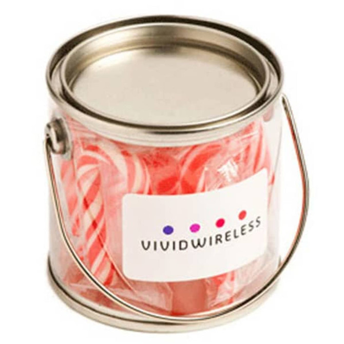A small clear PVC bucket filled with red and white candy canes, featuring a branding label.