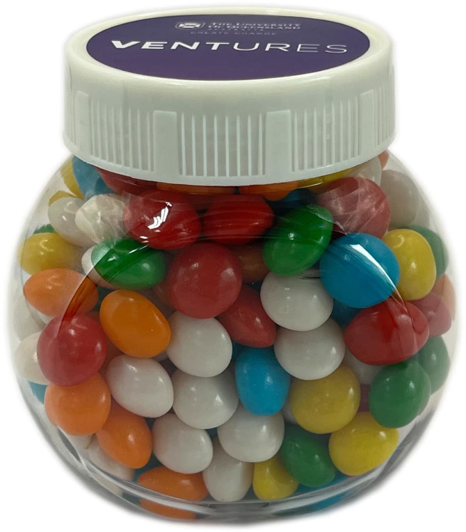 A clear plastic jar filled with colourful chewy fruit candies, including red, blue, green, yellow, and white.