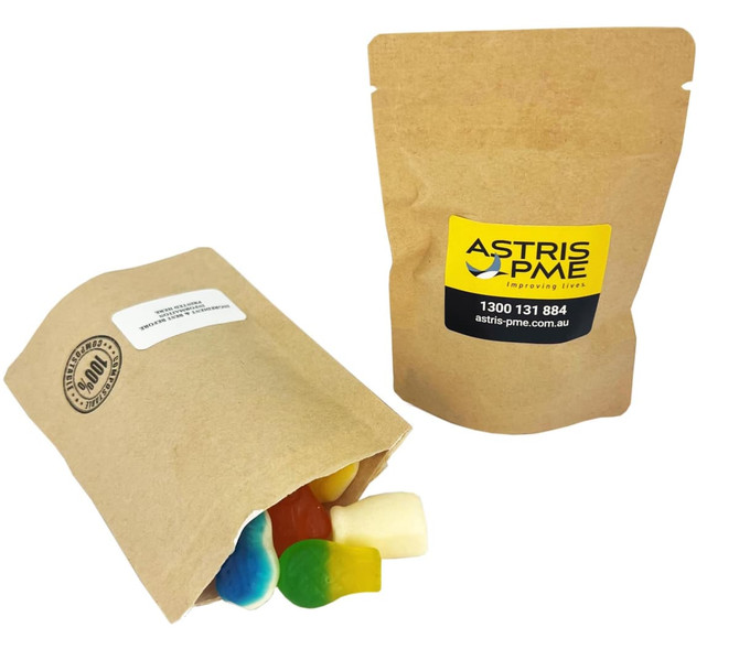 A compostable bag containing mixed lollies in various colours, with a simple brown paper exterior and a logo.