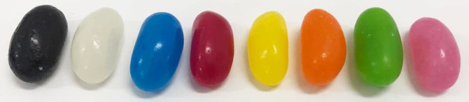 A row of jelly beans in various colours, including black, white, blue, red, yellow, orange, green, and pink.
