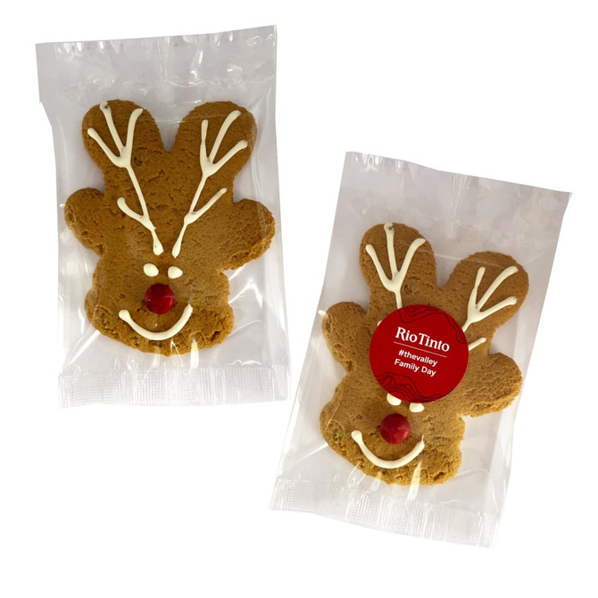 Gingerbread cookies shaped like reindeer, featuring white icing details and a red candy nose, packaged individually.