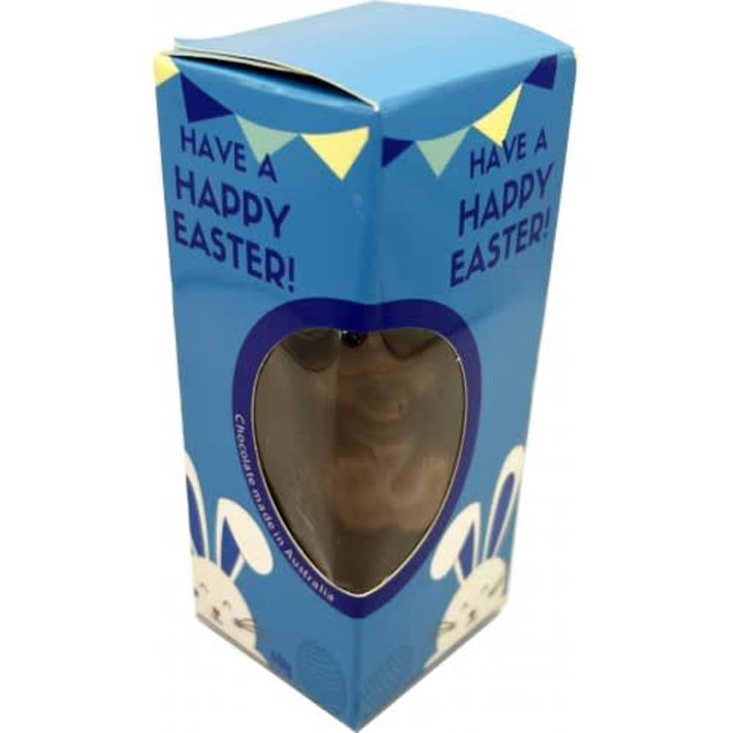 A blue cardboard box containing a chocolate Easter Bunny, with a transparent heart-shaped window.