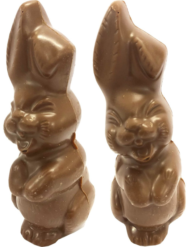A pair of chocolate Easter bunnies in light brown, featuring smiling expressions and detailed features.