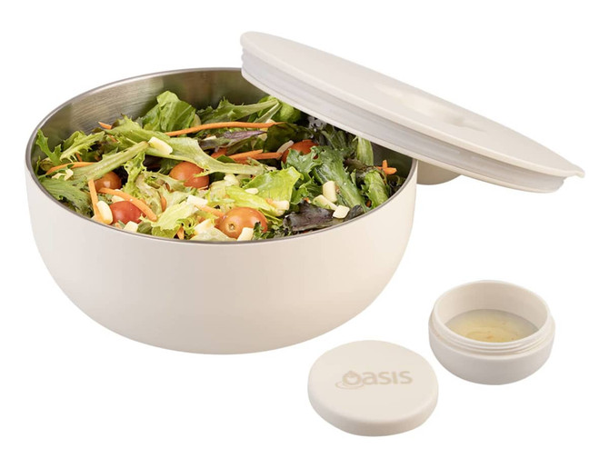 A salad bowl in cream colour with a lid, featuring fresh salad and a small container for dressing. It has a logo.