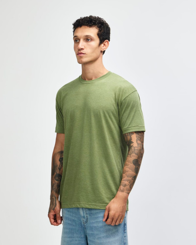 A unisex T-shirt in olive green, featuring a relaxed fit and short sleeves, displayed on a model with tattoos.