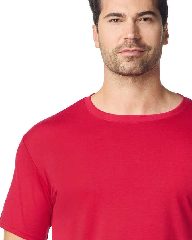 A red Gildan Performance adult t-shirt featuring a round neckline and short sleeves, with a logo on the fabric.