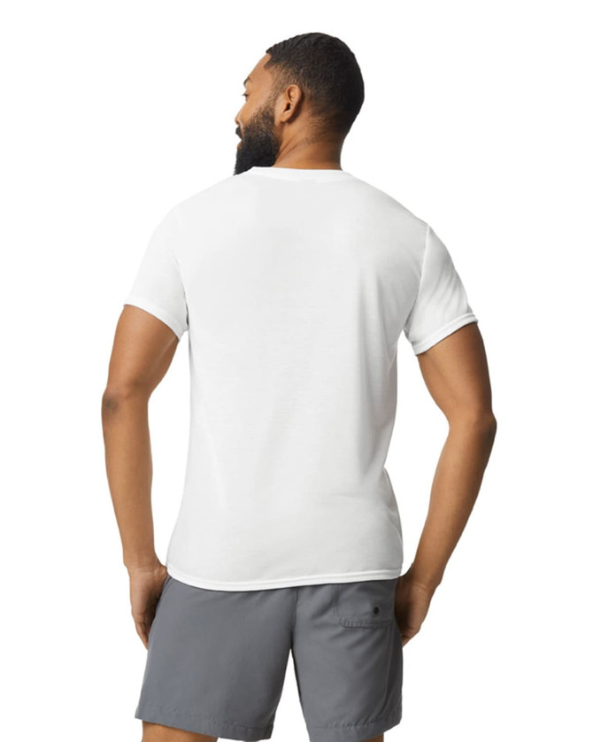A man wearing a white Gildan Performance adult t-shirt, viewed from the back, paired with grey shorts.
