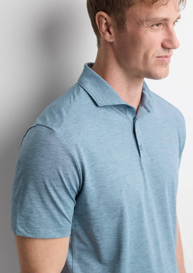 A men's short sleeve polo in a light blue colour with a collar and a logo on the chest.