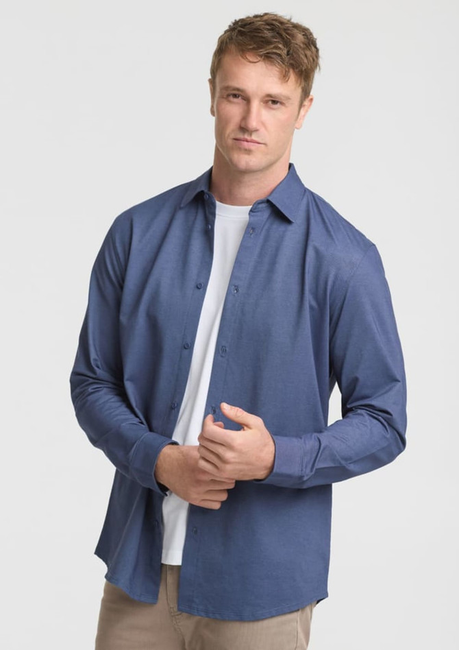 A long sleeve men's shirt in navy blue, featuring a button-up design and a branded logo.
