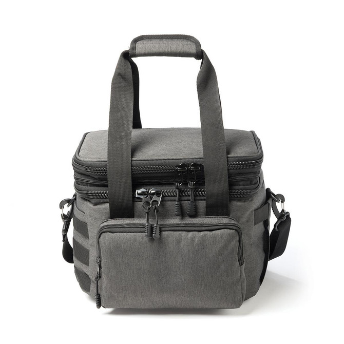 A grey expanding cooler with dual handles, zippers, and a front pocket, featuring adjustable straps and a logo.
