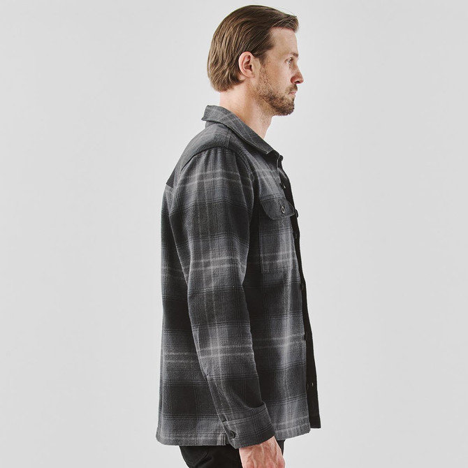 A men's Highland plaid shacket in grey, featuring a collared design and button front, displayed on a model in profile.