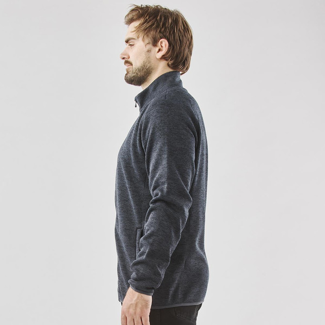 A men's full zip fleece jacket in dark navy, featuring a high collar and side pockets. It has a simple logo design.
