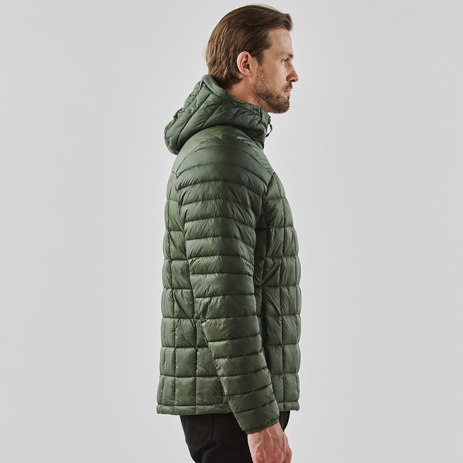 A olive green puffer jacket with a hood, featuring a quilted design. It has a logo on the garment.