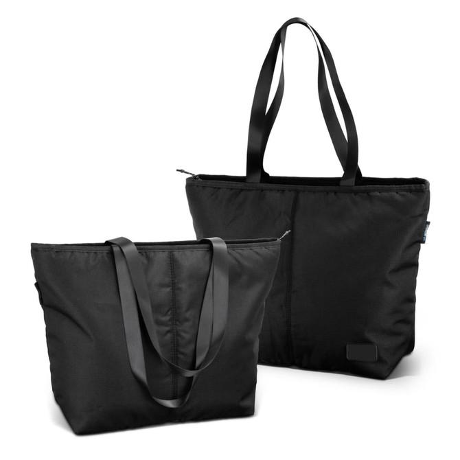 A black tote bag with long handles, featuring a zippered closure and a sleek design. It includes a small branding logo.