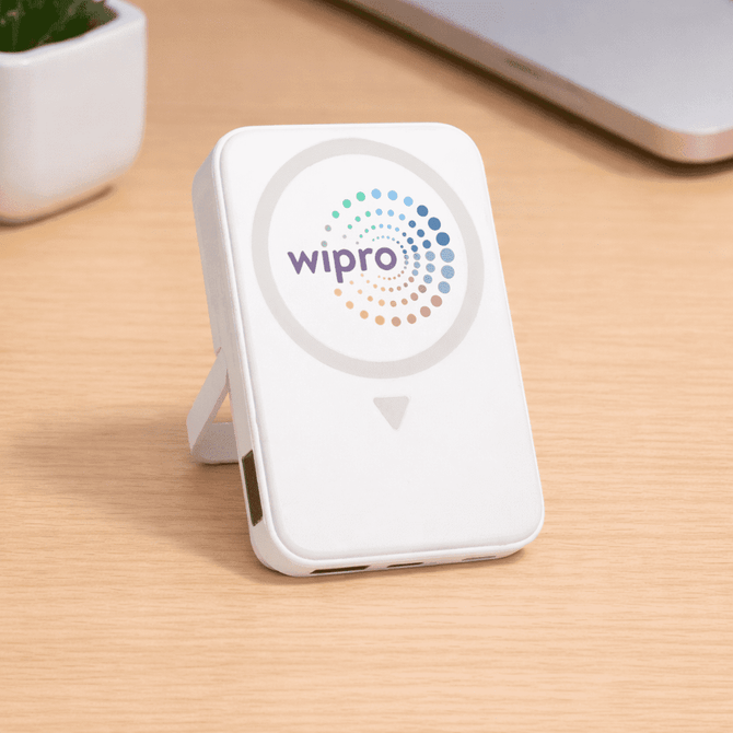 A white wireless charging power bank with a logo, featuring a stand and USB ports.